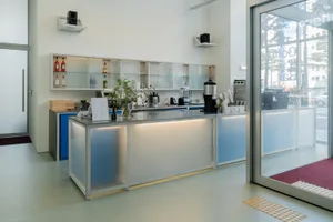 Modern glass coffee shop counter with sleek design and minimalist decor.