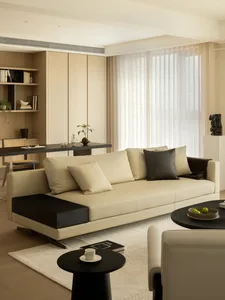 A modern minimalist living room with a comfortable sofa, a sophisticated black-and-white table, and a sleek black side table.