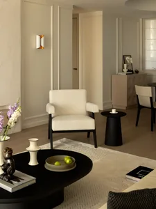 Modern minimalist living room with neutral-toned furniture and decor.