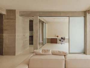 A modern office space featuring exposed concrete walls and a minimalist design.