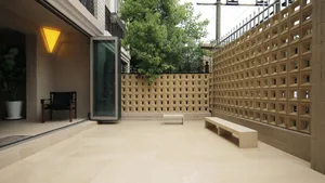 A modern garden featuring a minimalist design with concrete and brick materials.