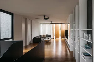Modern minimalist living room featuring wood flooring and minimalist furniture.