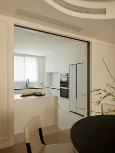Modern kitchen with minimalist design and sleek, contemporary materials like marble and stainless steel.
