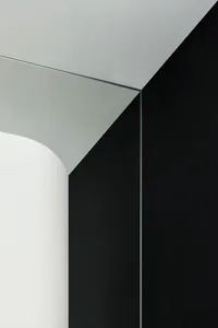 A modern black and white interior space featuring glass architectural elements.