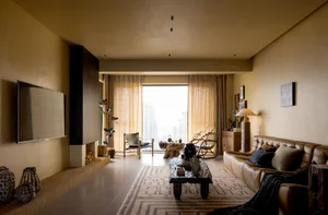 A chic living room with concrete walls, leather furniture, and industrial design elements.