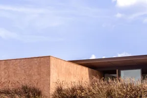 Modern, minimalist building exterior made of concrete materials.