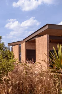 A modern building with a concrete exterior featuring a unique architectural design.