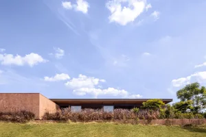 A modern house with a flat roof and concrete exterior.