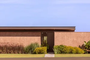 A minimalist modern house with a sandstone exterior