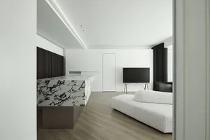 A modern living room featuring a sleek, minimalist design with a marble countertop and a stylish, textured sofa.