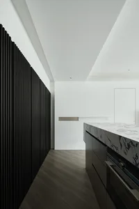 Modern minimalist kitchen featuring a marble countertop
