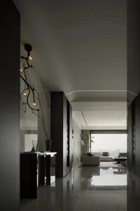 Modern minimalist living room with glass walls and marble flooring.