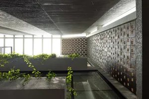 A minimalist urban courtyard with concrete structures and green plants.