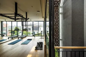 A modern workout room with wooden flooring and minimalistic design elements.
