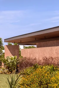 Modern residential exterior with concrete walls and a flat roof.