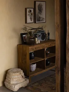 A wooden shelf with various industrial-style accessories and items.