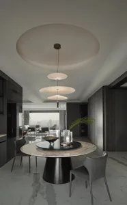 Modern dining room with marble flooring, metal and glass table, and red chair.