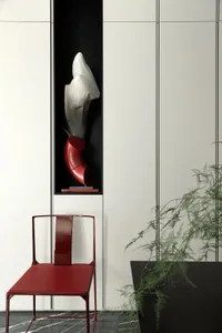 Modern interior design featuring a metallic and marble sculpture in a bright setting