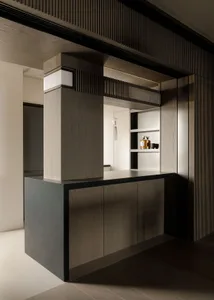 A dark wooden bar counter with a minimalist design, featuring a modern aesthetic and sleek lines.