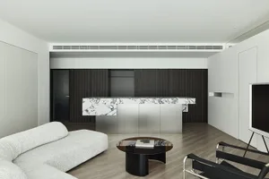 Modern living room featuring marble, stainless steel, and wood elements.