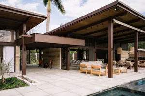 Modern patio space featuring concrete, wood, and glass materials.