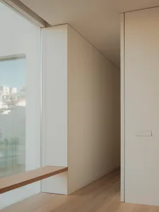 Modern minimalist interior design featuring glass windows and wooden surfaces.