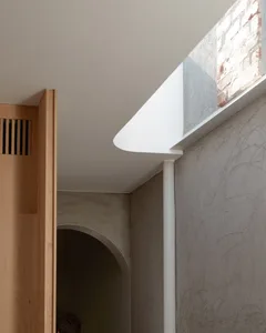 A modern apartment with a concrete floor and minimalist design elements.