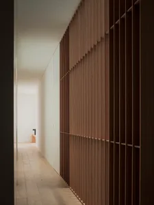 A modern interior design featuring a wooden wall paneling system.