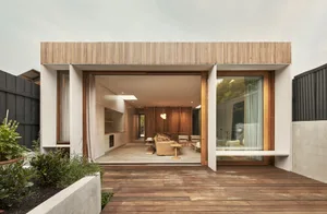 A modern, minimalist exterior with wooden panels and glass windows.