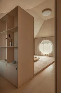 A minimalist room with wooden walls and a round window