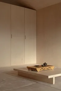 A minimalist interior design featuring wooden furniture and flooring.
