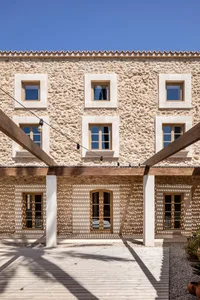 A stone building facade with wooden beams and blue sky