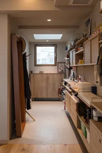 A minimalist closet with wooden shelves, cabinets, and racks.