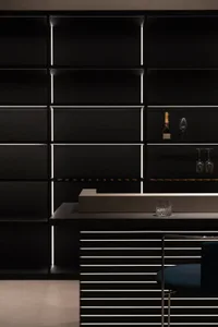 A modern minimalist bar with metal shelving and a sleek countertop.
