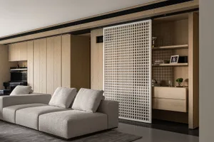 Contemporary living room featuring a comfortable couch in front of a large wooden-paneled entertainment center.