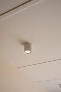 Modern minimalist ceiling light fixture on a white ceiling.