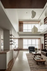 Modern living room with concrete fireplace, wooden furniture, and fabric seating.