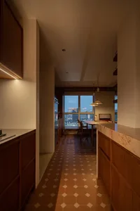 Modern minimalist kitchen featuring wooden cabinets, a marble countertop, and a reflective tiled floor.