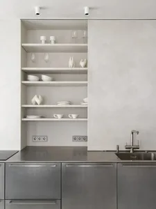 Modern, minimalist kitchen featuring open shelving and concrete finishes.