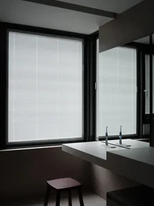 Bathroom interior featuring large windows with aluminum blinds.