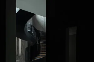 A modern black staircase with glass panel