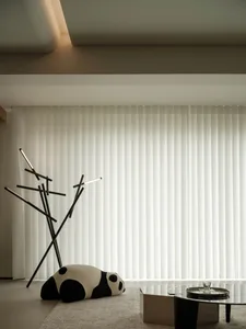 Contemporary living room with white vertical blinds, minimalist furniture, and a playful panda plush toy
