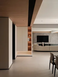 A modern living room featuring a composite wood, marble, and leather interior with a large television and plush seating.
