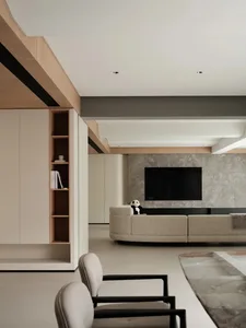 A modern living room featuring minimalist design with concrete walls, marble accents, and a fabric sofa.