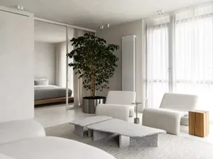 A modern living room with granite furniture, minimalist decor, and a large tree plant.