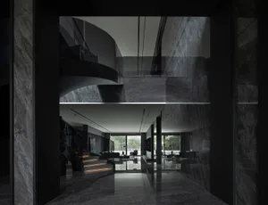 Modern interior design featuring marble materials and elegant black accents.