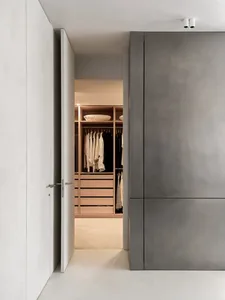Modern minimalist closet with wooden shelves and drawers.