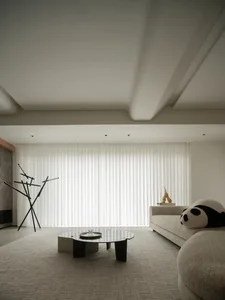 A modern minimalist living room with a neutral color palette, sleek furniture, and a large window with white vertical blinds.