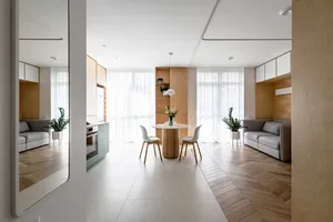 Modern minimalist living room with wood furniture and white walls.