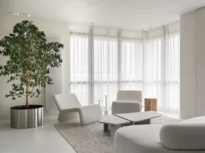 Modern living room featuring neutral-tones furniture and minimalistic decor.